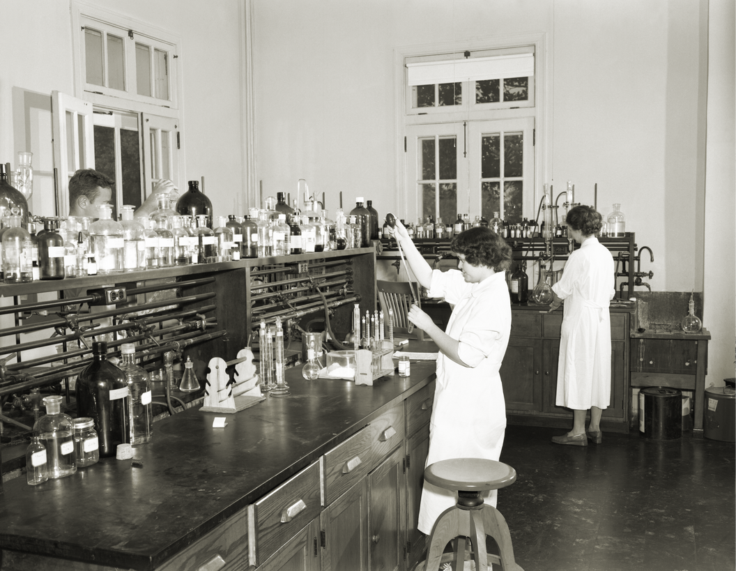 Three laboratorians inside one of the facility’s chemistry laboratories in the process of conducting scientific tests. Courtesy of the Public Health Image Library, Centers for Disease Control and Prevention.